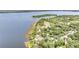Scenic aerial view of lakefront homes surrounded by lush trees at 1149 Shady Cove E Rd, Haines City, FL 33844