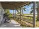 View of the covered back porch and waterfront view with relaxing rocking chair at 1149 Shady Cove E Rd, Haines City, FL 33844