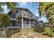 Two-story home featuring a large backyard with mature trees and a screened-in porch, perfect for enjoying the outdoors at 1149 Shady Cove E Rd, Haines City, FL 33844