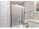Clean bathroom featuring tiled shower with gray and white striped shower curtain at 1149 Shady Cove E Rd, Haines City, FL 33844