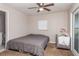 Comfortable bedroom with ceiling fan, gray walls, carpet and exterior access door to deck at 1149 Shady Cove E Rd, Haines City, FL 33844