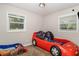 Fun bedroom with themed car beds and natural light from two windows at 1149 Shady Cove E Rd, Haines City, FL 33844