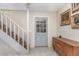 Foyer view with gray door, stairway and cabinet against the wall at 1149 Shady Cove E Rd, Haines City, FL 33844