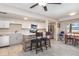 Modern kitchen features white cabinets, breakfast bar and views of the dining room at 1149 Shady Cove E Rd, Haines City, FL 33844