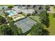 Aerial view of a clubhouse with pool, tennis courts and beautifully landscaped grounds at 2925 Dayton Dr, Winter Haven, FL 33884