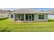 A house featuring a screened patio, well-maintained lawn, and neat landscaping around the perimeter at 2925 Dayton Dr, Winter Haven, FL 33884