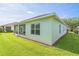 Exterior view of a home showcasing a screened-in lanai with a beautiful lawn at 2925 Dayton Dr, Winter Haven, FL 33884