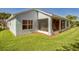 A partially screened outdoor seating area surrounded by a well maintained lawn, with an air conditioner placed outside at 2925 Dayton Dr, Winter Haven, FL 33884