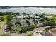A scenic aerial view of a clubhouse with lake backdrop and landscaped grounds at 2925 Dayton Dr, Winter Haven, FL 33884