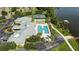 Aerial view of the community's pool, tennis courts, lake, and clubhouse at 2925 Dayton Dr, Winter Haven, FL 33884