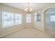 Bright dining room featuring ample natural light, carpeted floors, and a chandelier, perfect for intimate gatherings at 2925 Dayton Dr, Winter Haven, FL 33884