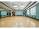 Spacious, well-lit exercise room with padded floor, mirrored wall, and seating at 2925 Dayton Dr, Winter Haven, FL 33884