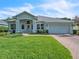 Charming one-story home with a well-manicured lawn and a brick driveway, featuring a two-car garage and inviting curb appeal at 2925 Dayton Dr, Winter Haven, FL 33884