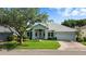 Charming single-story home with lush landscaping, a brick driveway, and a two-car garage at 2925 Dayton Dr, Winter Haven, FL 33884
