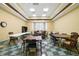Bright game room with checkerboard tile floor, tables, chairs, and natural light at 2925 Dayton Dr, Winter Haven, FL 33884