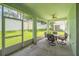 View of a screened in lanai with a table, chairs and access to the backyard at 2925 Dayton Dr, Winter Haven, FL 33884