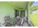 Covered lanai featuring a ceiling fan, sliding glass doors, grill and an outdoor dining set at 2925 Dayton Dr, Winter Haven, FL 33884