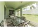 Screened lanai with a dining set, grill and view of the backyard at 2925 Dayton Dr, Winter Haven, FL 33884