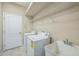A well-equipped laundry room featuring a washer, dryer, utility sink, wire shelving and a door at 2925 Dayton Dr, Winter Haven, FL 33884