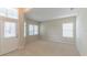 Bright living room with carpeted floors, large windows, and a decorative front door providing an inviting and airy ambiance at 2925 Dayton Dr, Winter Haven, FL 33884