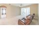 Bright living room features a ceiling fan, sliding glass doors and neutral carpet at 2925 Dayton Dr, Winter Haven, FL 33884