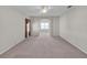 Large living room with carpeted floors, ceiling fan, and natural light at 2925 Dayton Dr, Winter Haven, FL 33884