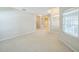 Large living room featuring carpet flooring, ample natural light, and open doorways for a spacious feel at 2925 Dayton Dr, Winter Haven, FL 33884