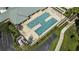 Aerial view of a large community pool with sun loungers, hot tub and palm trees at 2925 Dayton Dr, Winter Haven, FL 33884