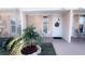 Charming front porch with a welcome wreath and seating area for relaxing at 4733 Club Cir, Lakeshore, FL 33854