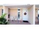 Charming front porch with a welcome wreath and seating area for relaxing at 4733 Club Cir, Lakeshore, FL 33854