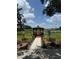 Charming gazebo surrounded by lush landscaping and a serene lake view, perfect for relaxation at 4733 Club Cir, Lakeshore, FL 33854