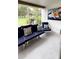 Cozy porch featuring stylish navy seating, and bright sunlight at 4733 Club Cir, Lakeshore, FL 33854