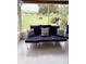 Enclosed porch with comfortable navy seating, offering a relaxing outdoor living space at 4733 Club Cir, Lakeshore, FL 33854