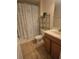 Cozy bathroom featuring a shower/tub combo with decorative curtain and ceramic tile flooring at 8923 Cuban Palm Rd, Kissimmee, FL 34747