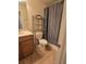 Standard bathroom featuring shower with curtain, commode, and vanity with sink at 8923 Cuban Palm Rd, Kissimmee, FL 34747