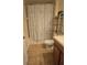 Functional bathroom featuring a sink with vanity, toilet, tub, and a floral patterned curtain at 8923 Cuban Palm Rd, Kissimmee, FL 34747