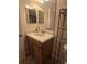 Functional bathroom with neutral tones, a sink with cabinet, and a well-lit mirror at 8923 Cuban Palm Rd, Kissimmee, FL 34747