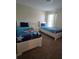 Shared ' bedroom with plush carpet, two beds with 'Toy Story' bedding, and a bedside table at 8923 Cuban Palm Rd, Kissimmee, FL 34747
