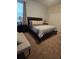 Cozy bedroom with a queen bed, side tables, and matching lamps at 8923 Cuban Palm Rd, Kissimmee, FL 34747