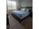 Bedroom features a queen sized bed, carpeting, and curtains at 8923 Cuban Palm Rd, Kissimmee, FL 34747