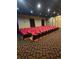 The spacious cinema features comfortable red seating and a large viewing screen at 8923 Cuban Palm Rd, Kissimmee, FL 34747