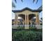 The impressive clubhouse entrance features towering columns and lush landscaping for an appealing welcome at 8923 Cuban Palm Rd, Kissimmee, FL 34747