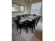 Formal dining room featuring a large dining table set for ten guests at 8923 Cuban Palm Rd, Kissimmee, FL 34747