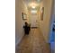 Hallway featuring tile floors, and decor leading to a white door at 8923 Cuban Palm Rd, Kissimmee, FL 34747