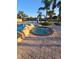 Another view of the community hot tub with steps, stonework, and lush landscaping at 8923 Cuban Palm Rd, Kissimmee, FL 34747
