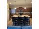 Open kitchen with a large island, granite countertops, and stainless steel appliances at 8923 Cuban Palm Rd, Kissimmee, FL 34747