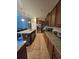 Modern kitchen with granite counters, stainless appliances, and open layout to living area at 8923 Cuban Palm Rd, Kissimmee, FL 34747
