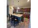 Well-equipped kitchen with a central island, stainless steel appliances, and granite countertops at 8923 Cuban Palm Rd, Kissimmee, FL 34747