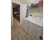 Well-equipped laundry room with a washer, dryer, and access to the kitchen at 8923 Cuban Palm Rd, Kissimmee, FL 34747