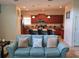 Open-concept living room with a view of the kitchen and an island with barstool seating at 8923 Cuban Palm Rd, Kissimmee, FL 34747